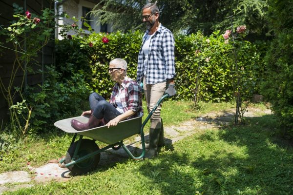 Mature couple enjoy working at their garden